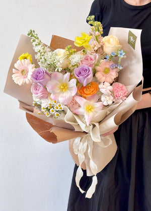A girl is wearing black long dress is holding a korean style bouquet for her birthday event at Kuala Lumpur.