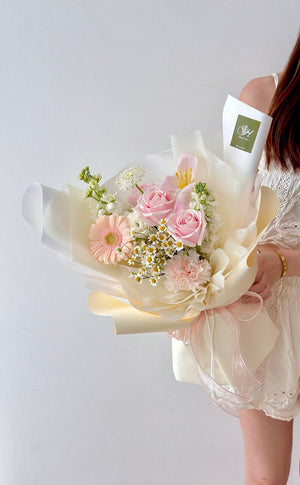 A woman showcases a mixed bouquet of tulips and gerbera flowers, celebrating a birthday during a cheerful photoshoot.