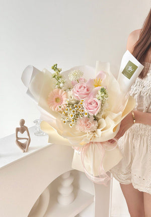 woman poses with a colorful bouquet of tulips and gerbera flowers for a birthday photoshoot, radiating happiness.