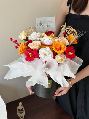 A cheerful soap flower box with vibrant blooms and a smiling Maneki-neko (beckoning cat) symbolizing good luck and positive vibes.