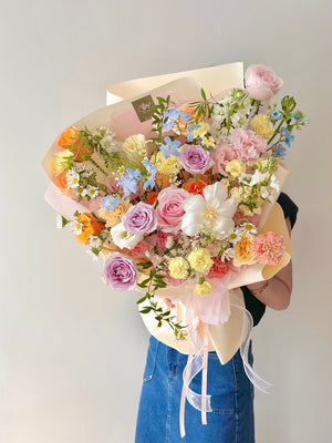 Soft-toned floral arrangement wrapped in cream and pink paper, exuding a romantic and gentle charm.