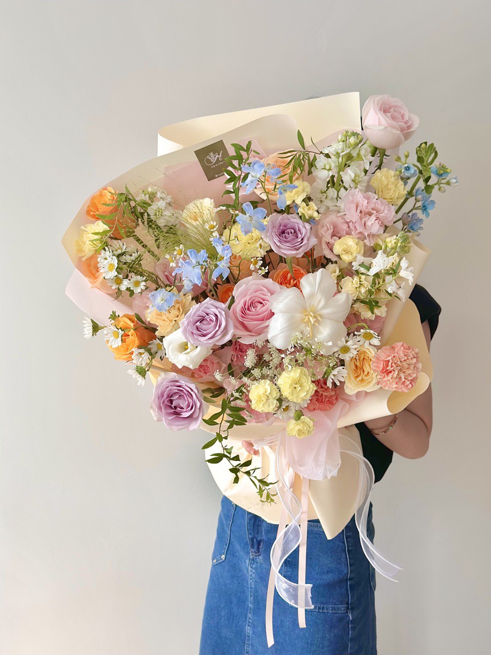 Soft-toned floral arrangement wrapped in cream and pink paper, exuding a romantic and gentle charm.