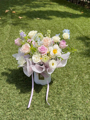Luxury lilac and white flower box with roses and spring flowers for housewarming gifts.