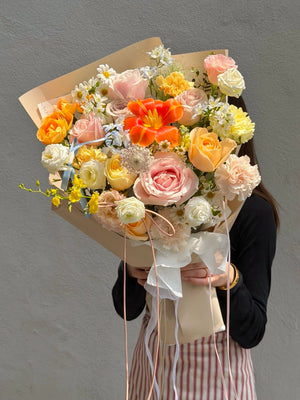 Elegant orange tulip flower bouquet with soft pink roses, buttercup roses, carnations and blue delphinium, perfect for birthday surprise, anniversary gift and same day flower delivery in Kuala Lumpur and Selangor.