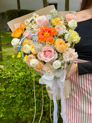 Premium pastel flower bouquet featuring vibrant orange tulip, blush pink roses, cream buttercup roses, carnations and delphinium blue flowers for birthdays, anniversaries and just because moments in KL and Selangor.