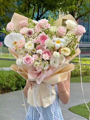 Romantic pink and white flower bouquet perfect for weddings or anniversaries, styled with ribbon and soft greenery.
