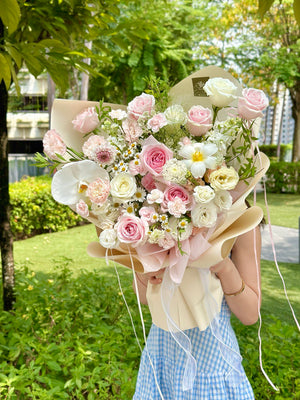 Feminine floral mix with orchids, garden roses, and daisies, creating a soft and graceful aesthetic.