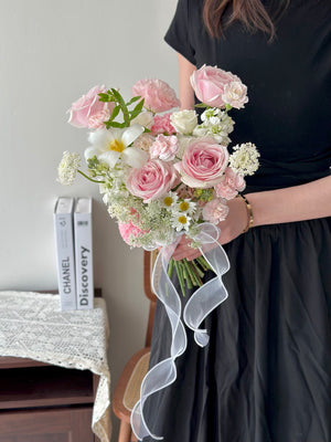 Elegant hand-tied bridal bouquet with pink roses, whitetulip, carnations, and delicate filler flowers.