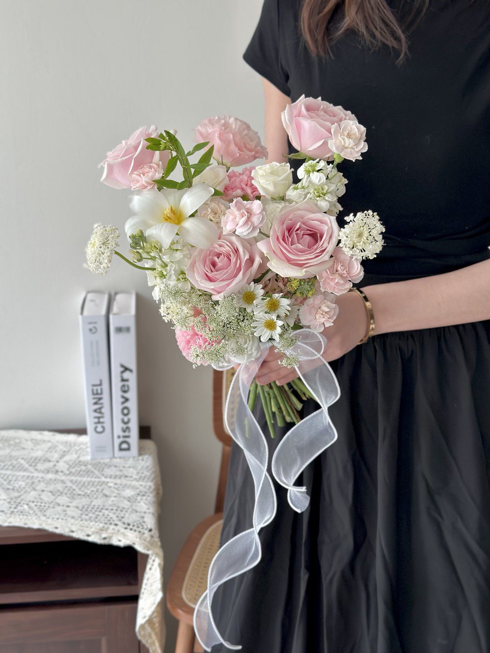 Elegant hand-tied bridal bouquet with pink roses, whitetulip, carnations, and delicate filler flowers.