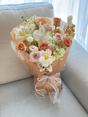A bouquet of cappuccino roses is placing on a sofa for a photoshoot at Kuala Lumpur.