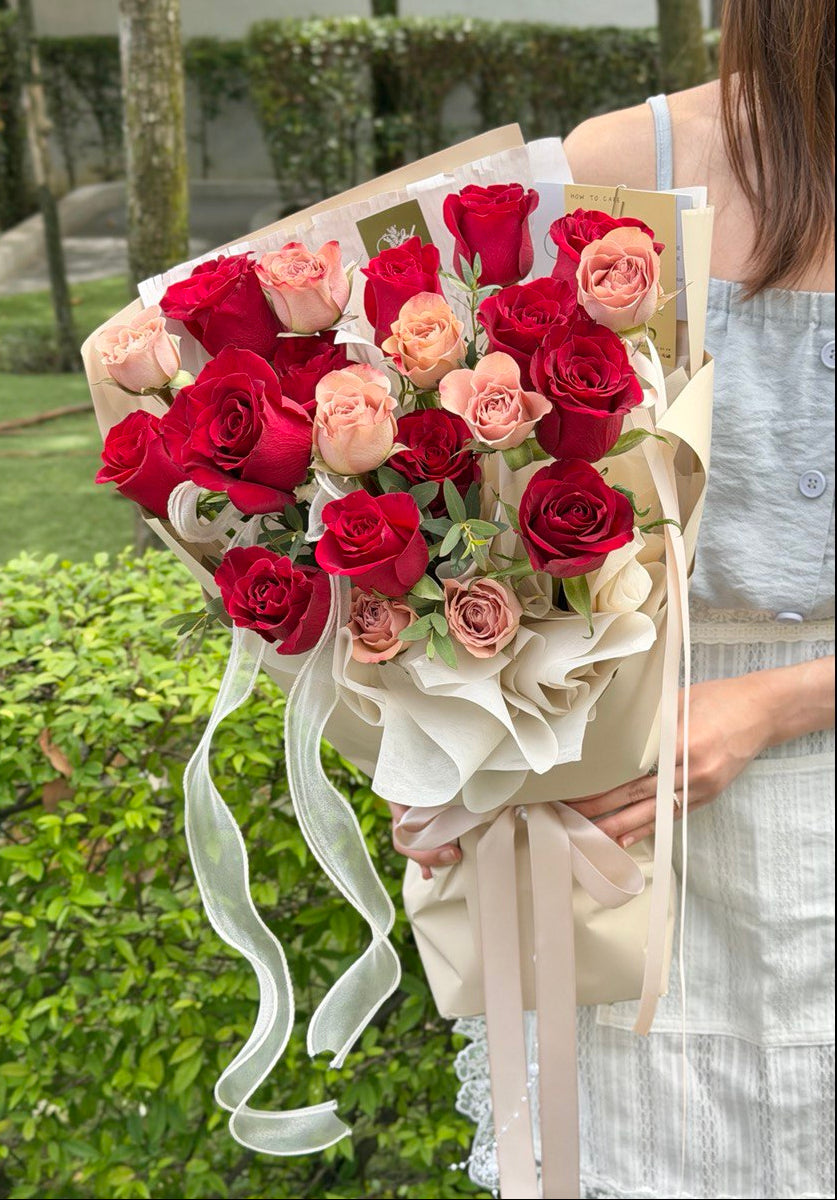 A bouquet of Red and Cappuccino Rose held by a girl at outdoor ideal gift for birthday, anniversary or Valentine's Day at Kuala Lumpur with same-day delivery.