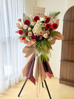 Beautiful congratulation flower stand with red gerberas, champagne roses, white hydrangea and fresh seasonal flowers. Generous-sized grand opening flower stand by Hug and Heart Florist with same day delivery in KL and Selangor.