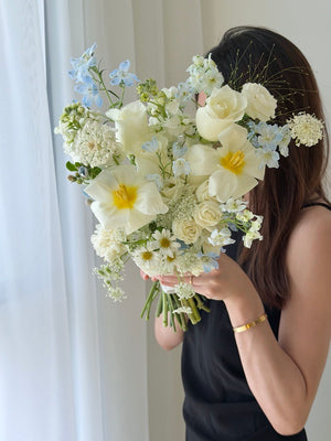 Romantic white and blue bridal bouquet with tulips, white roses, delphinium blue and oxypetalum blooms, ideal for wedding solemnization and ROM in Kuala Lumpur.