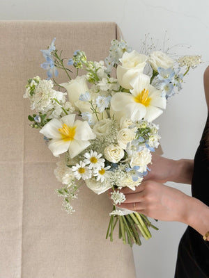 Modern minimalist ROM bouquet crafted with white tulips, white roses, blue delphinium and oxypetalum flowers, elegant wedding flower delivery service in KL and Selangor.