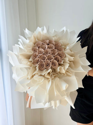 A bouquet of cappuccino rose soap flower wrapped in ballet wrapper perfect for proposal flower.