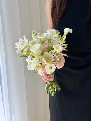 Modern wedding hand bouquet with white calla lily, tulip, astilbe, white roses and soft pink roses for brides, available with same day flower delivery in Kuala Lumpur.