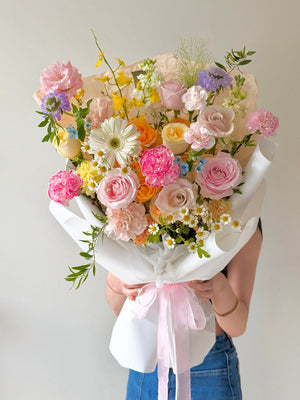 Soft pastel flower bouquet with roses, carnations and daisies, elegant gift arrangement for birthday or celebration.