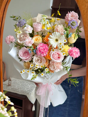 A bouquet of colourful flower consist of gerbera, pink rose, menta rose, orange rose spray, dye carnation and other green fillers perfect for birthday flower gift.