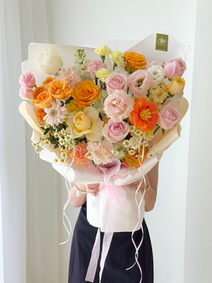 Soft pastel mixed flower bouquet with orange tulip, buttercup roses and pink roses, perfect birthday flower bouquet with same day flower delivery Kuala Lumpur Selangor.