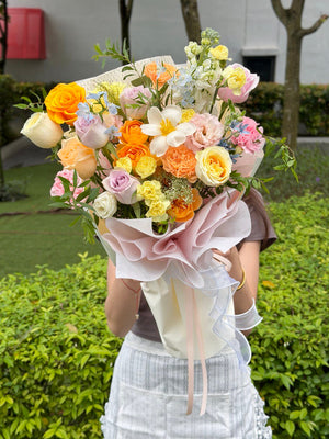 Cheerful pastel flower bouquet with yellow roses and soft pink blooms, ideal for celebration and congratulations.