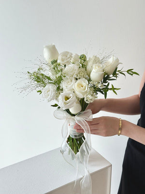 A white tone ROM flower is holding by a hand preparing for her wedding at Kuala Lumpur.