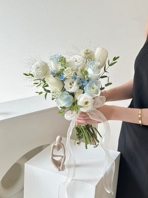 oft-toned romantic bouquet with blue and white roses, symbolizing purity and new beginnings—ideal for registry weddings.