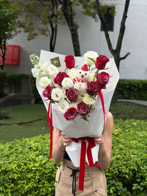 A bouquet of Christmas flower bouquet with a ping pong snow man held by a girl outdoor, perfect for Christmas gift.