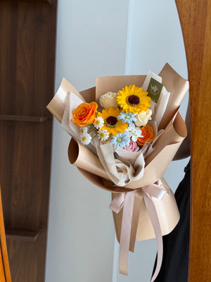 A girl is holding a bouquet of soap flower in front of a mirror, flower prepare by hug and heart florist subang jaya.