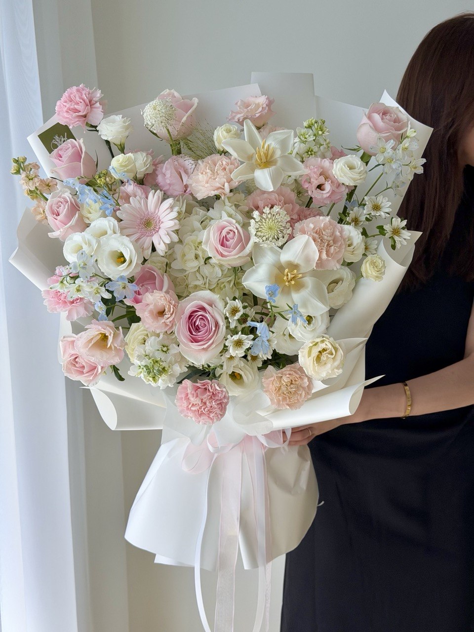 Premium flower bouquet with one white hydrangea, pink roses, carnations and white tulip for birthday surprise.