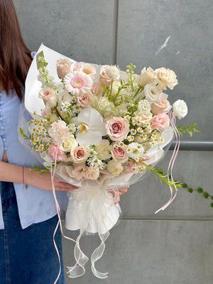 Luxury flower bouquet featuring Quicksand roses, white phalaenopsis, and chamomile in Malaysia.