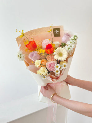 Close-up of a pastel and vibrant mixed flower bouquet with gentle textures and layers, perfect for a romantic or celebratory occasion.