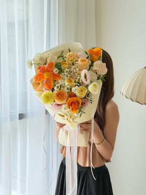 Premium orange tulip flower arrangement with white roses and pastel flowers for Mother's Day, anniversaries, and special occasions.