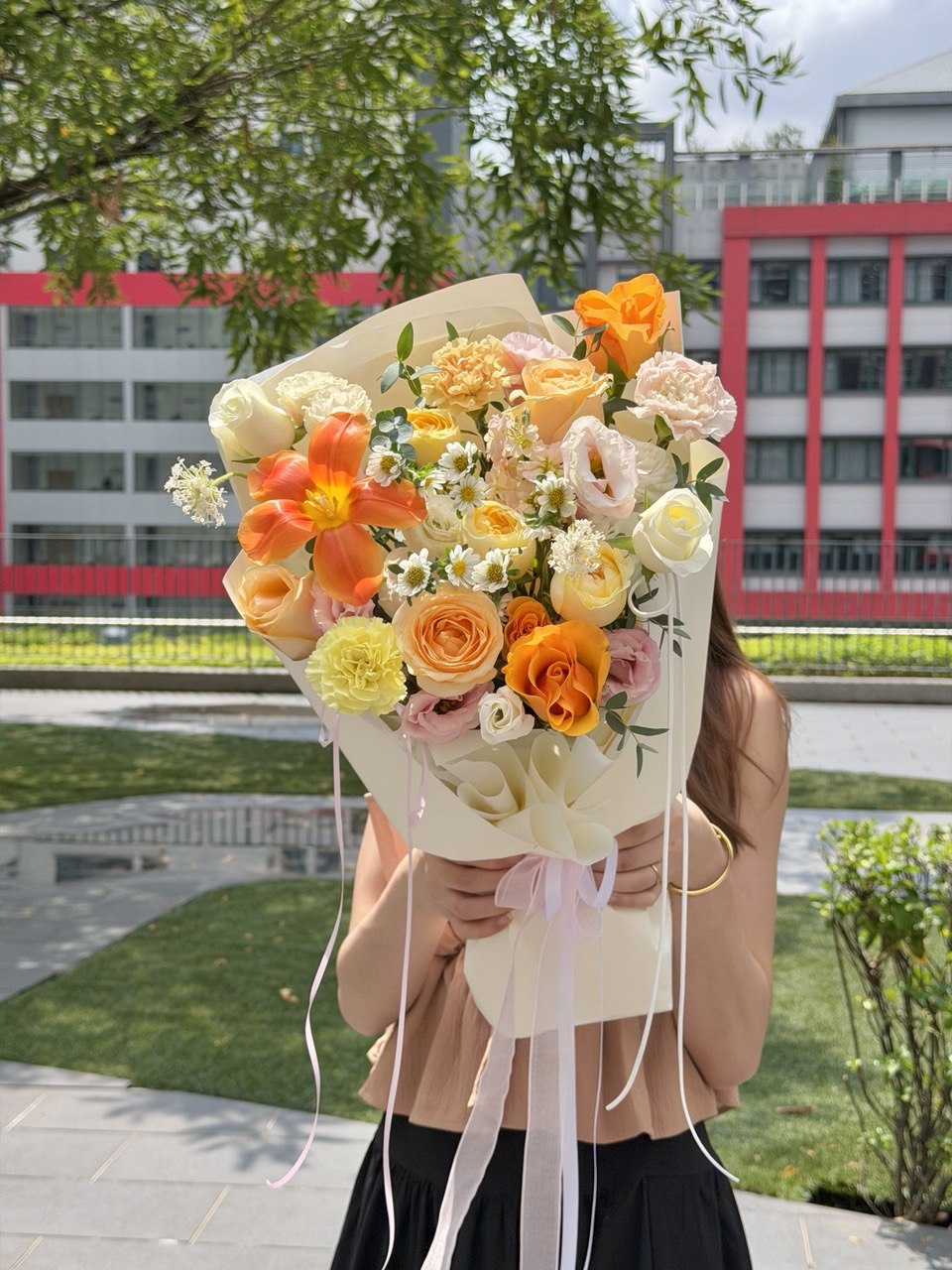 Premium orange tulip flower arrangement with white roses and pastel flowers for Mother's Day, anniversaries, and special occasions.