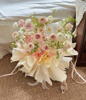 Elegant pastel rose and gerbera daisy bouquet with white phalaenopsis accents, wrapped in luxury cream paper – Malaysia florist arrangement.
