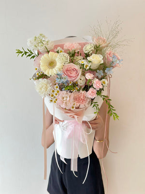 Person holding a bouquet of flowers against a plain background perfect for anniversaries or birthdays.