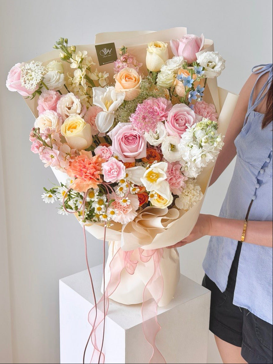 Pastel mixed flower bouquet with roses, carnations, and daisies in elegant cream wrapping same day flower delivery Kuala Lumpur and Selangor.