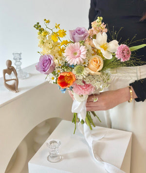 A bride with a radiant bouquet of ROM flowers, symbolizing joy and enriching the ambiance of her special wedding day.