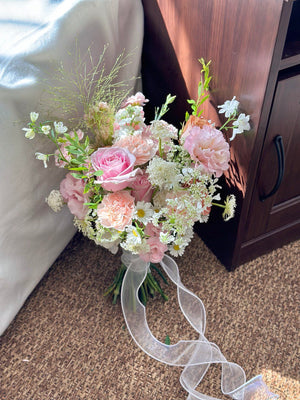 Rustic-meets-romantic bridal bouquet with soft garden roses, wildflowers, and textured greenery.