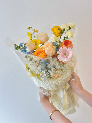 In Subang Jaya, a woman is holding a vibrant bouquet of mixed Korean flowers.