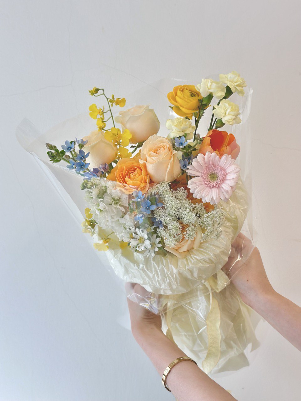 In Subang Jaya, a woman is holding a vibrant bouquet of mixed Korean flowers.