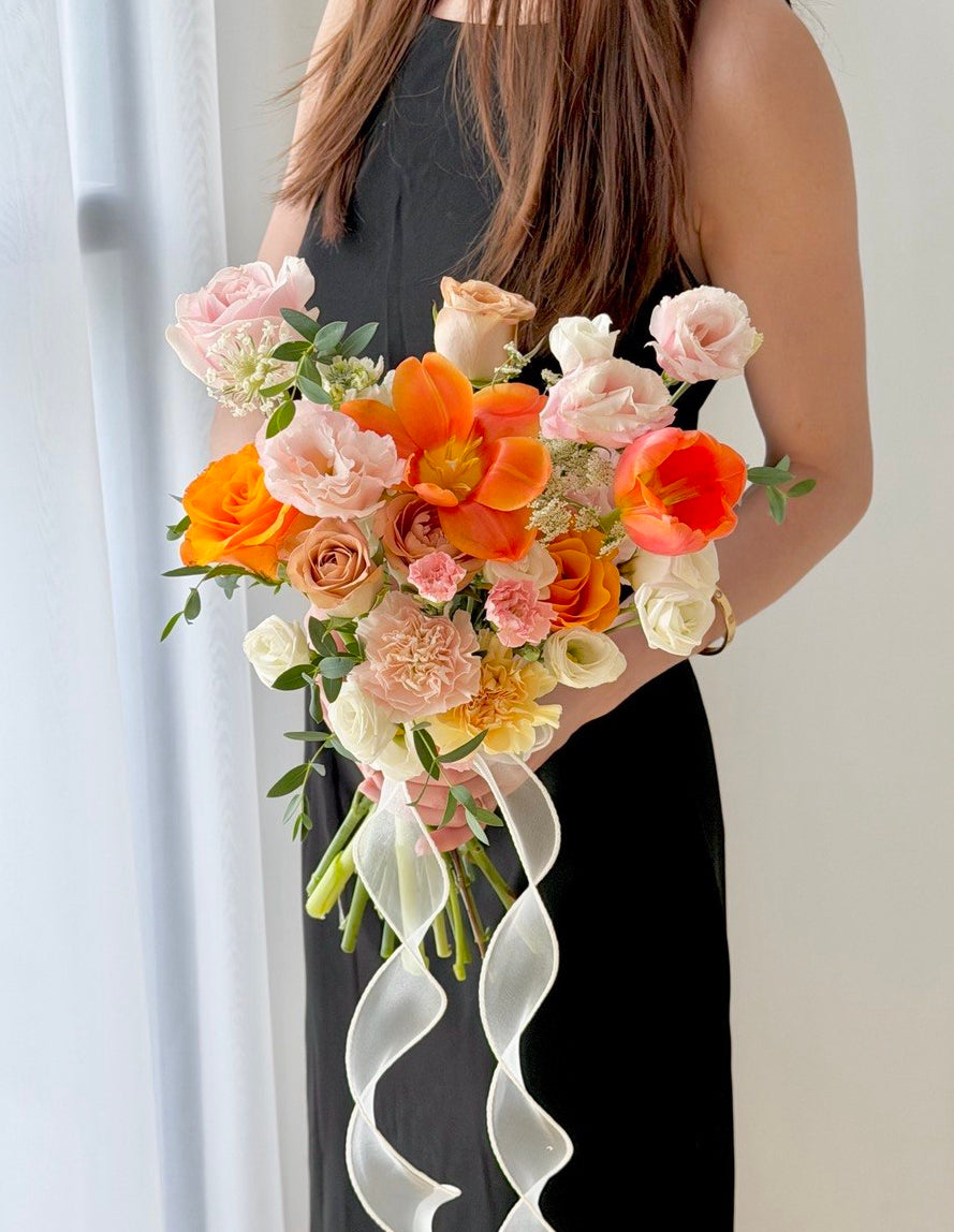 Orange tulip wedding hand bouquet with pink roses, blush carnations and white eustoma for elegant bridal wedding in Kuala Lumpur.