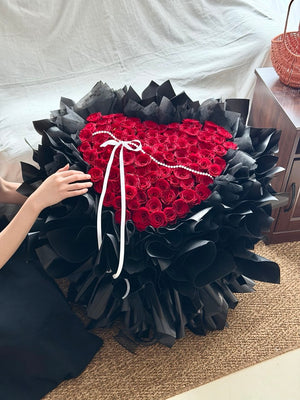 Premium 99 red rose bouquet wrapped in black paper for romantic proposals and anniversaries in Selangor.