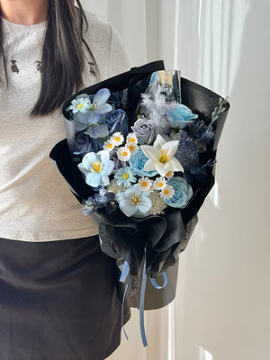 Luxury dark blue soap flower bouquet with white lily, pastel blue roses, tulips, and preserved floral accents for graduation, birthday, and anniversary gifts.