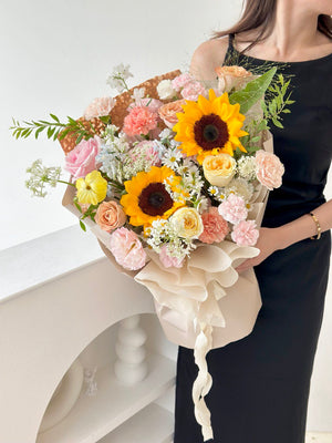 Bright sunflower bouquet held by a woman in a black dress, perfect for celebrating a university graduation.