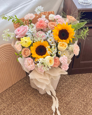 Elegant mixed flower bouquet featuring sunflowers, perfect for congratulating a university graduate on their big day.