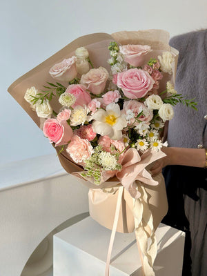 Charming bouquet of blush pink and cream flowers, perfect for romantic occasions or gentle celebrations.