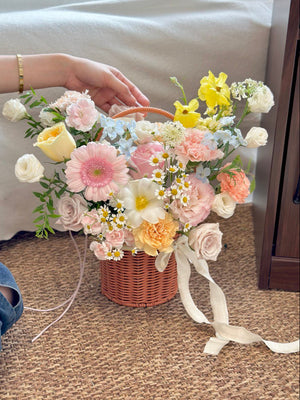 A pastel flower basket with daisies, gerberas, roses, and carnations, perfect for a “get well soon” gesture.