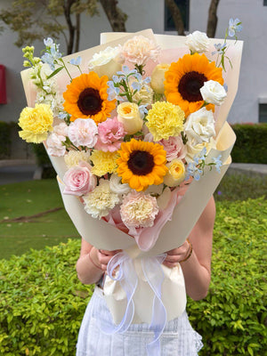A sunflower bouquet mixed with buttercup rose and pink rose perfect for graduation flower gift at Sunway University.