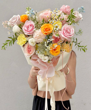 Fresh floral bouquet with soft pink roses and cheerful yellow accents, perfect for celebrations or gifting.