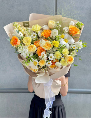 Elegant hand bouquet with roses, carnations, daisies, and greenery, ideal for celebrations or thoughtful gifting.